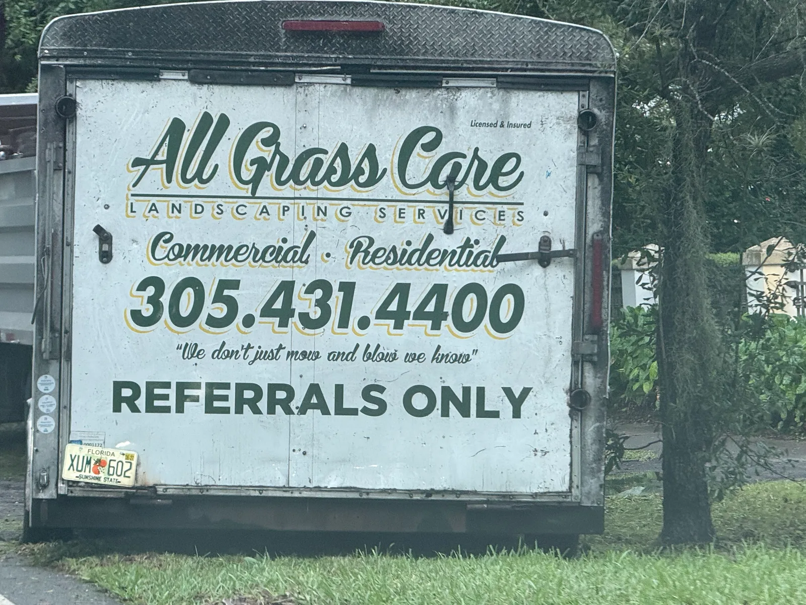 All Grass Care work vehicle displaying its business name and contact information