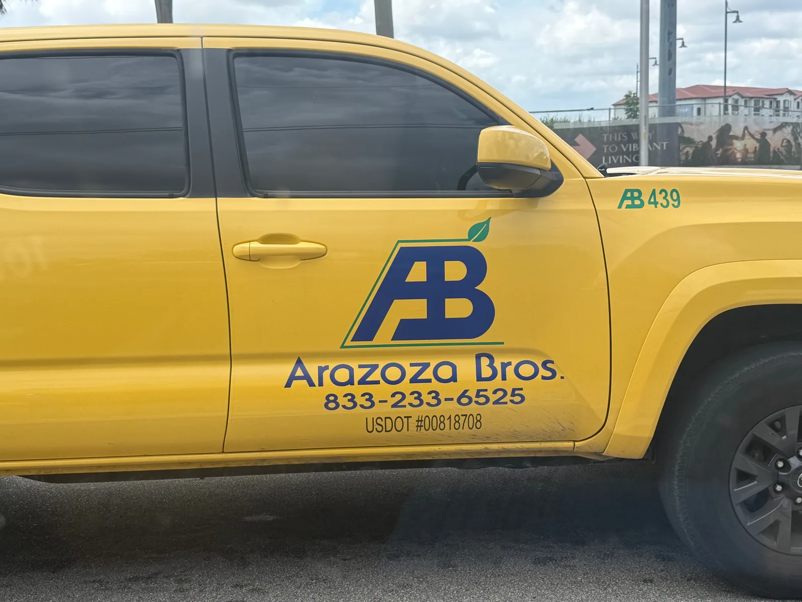 Arazoza Brothers commercial-landscaping truck displaying phone number 833-233-6525 and USDOT 00818708