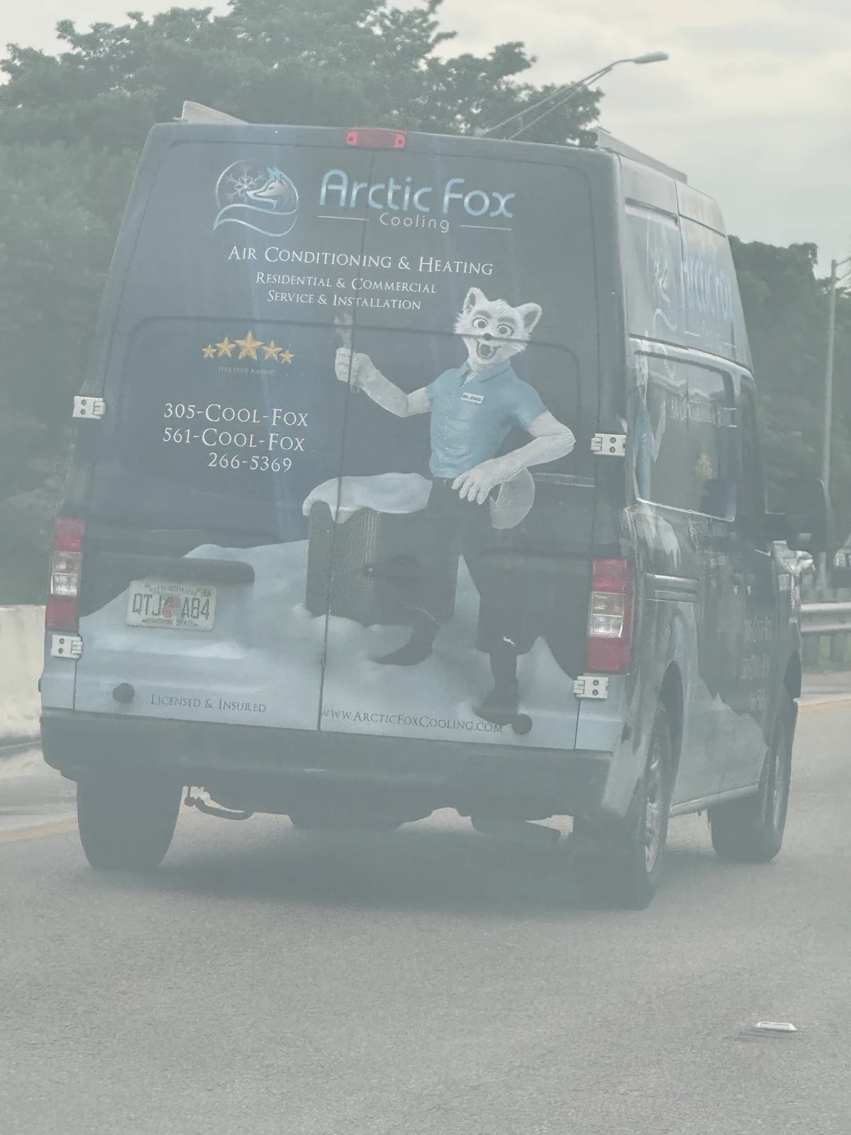 Arctic Fox Cooling work vehicle displaying business contact information