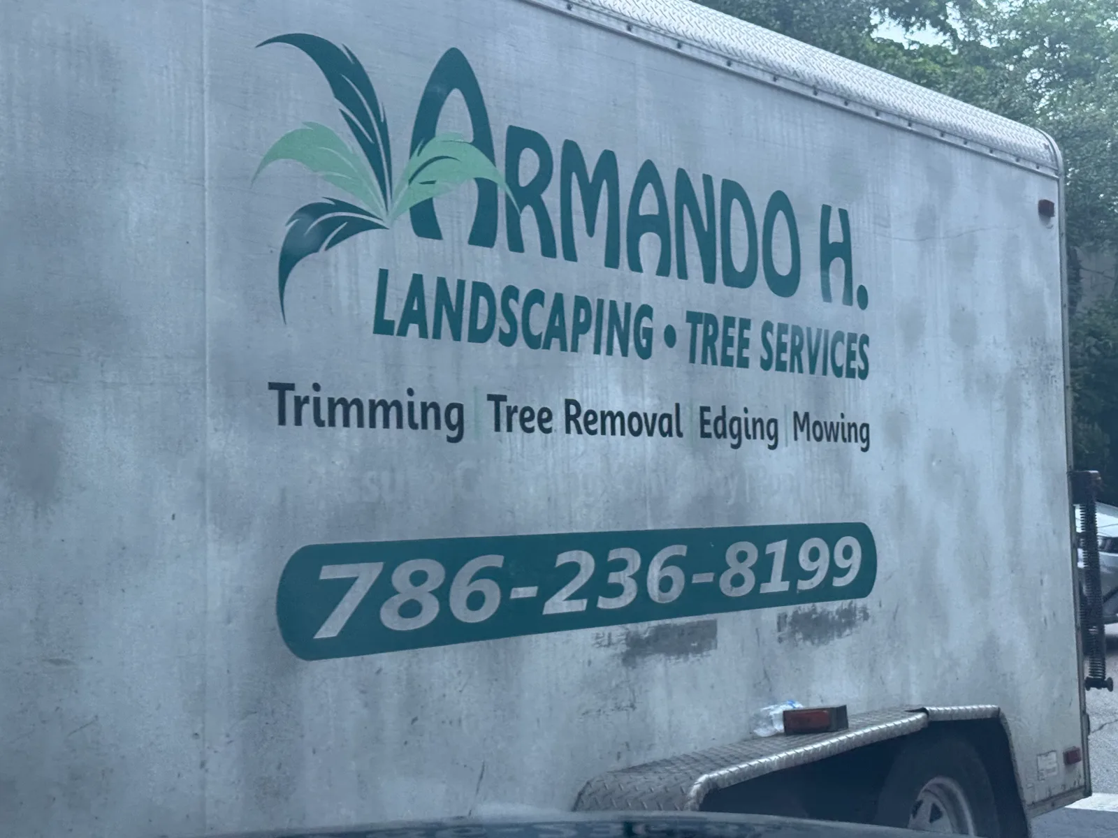 Armando H. Landscaping & Tree Services work vehicle displaying its business name and contact information