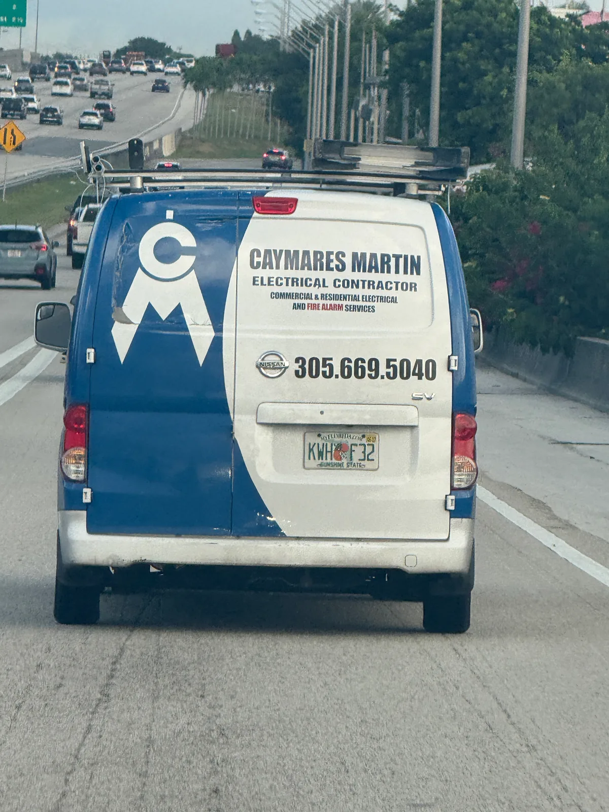 Blue and white Caymares Martin Electrical Contractor van displaying phone number 305-669-5040
