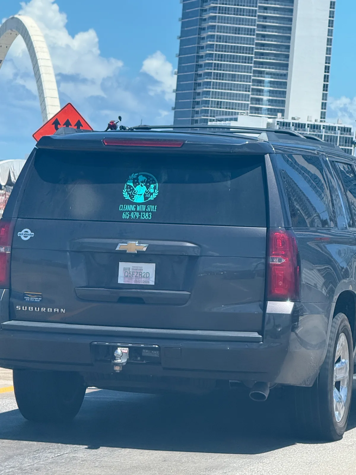 Dark SUV displaying a Cleaning With Style logo and phone number 561-579-1383