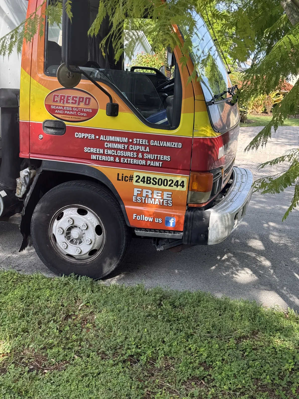 Orange Crespo Seamless Gutters and Paint work truck showing gutter services and contact details — photo 2 of 2