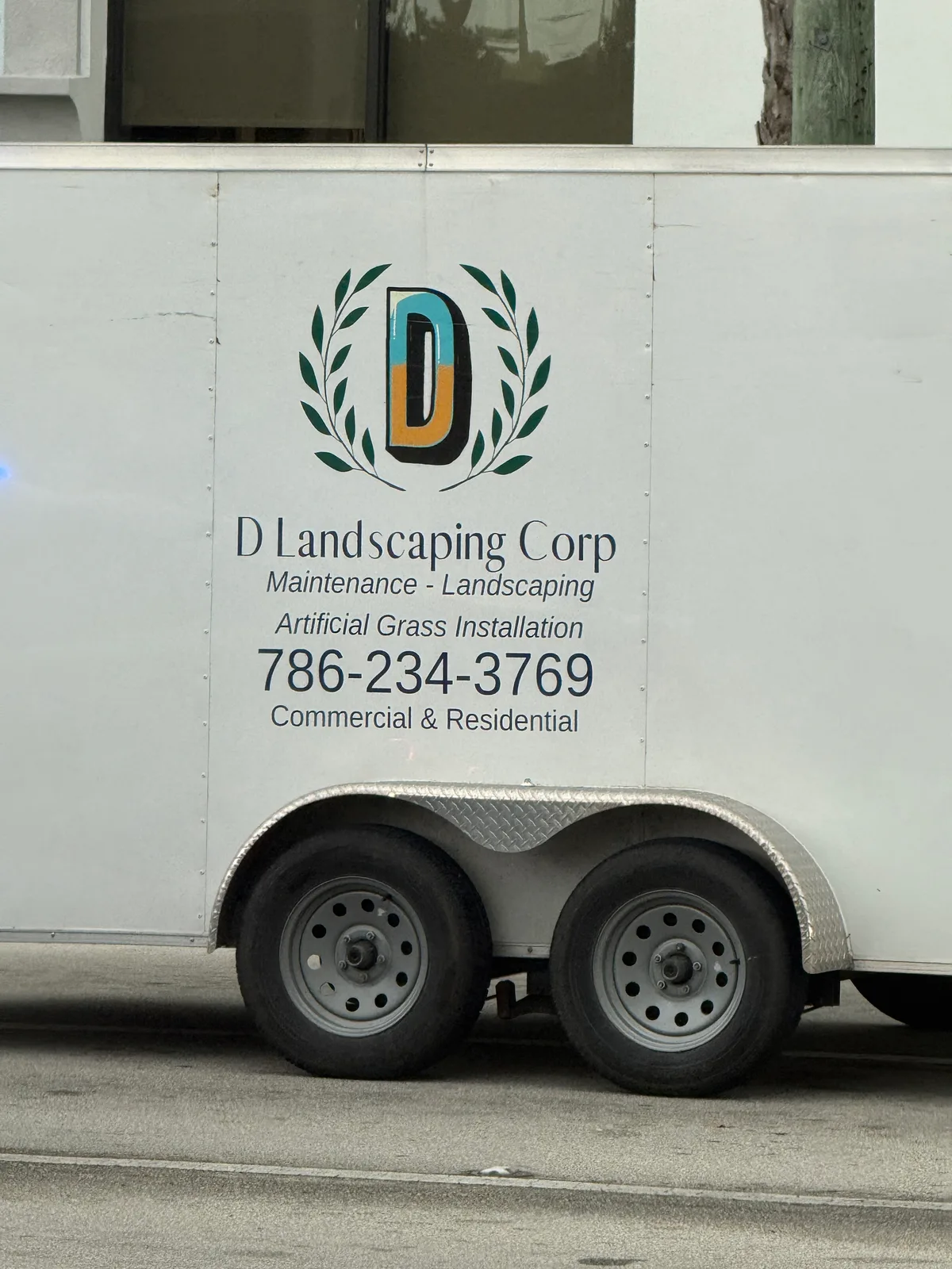 D Landscaping Corp work vehicle displaying its business signage and contact information