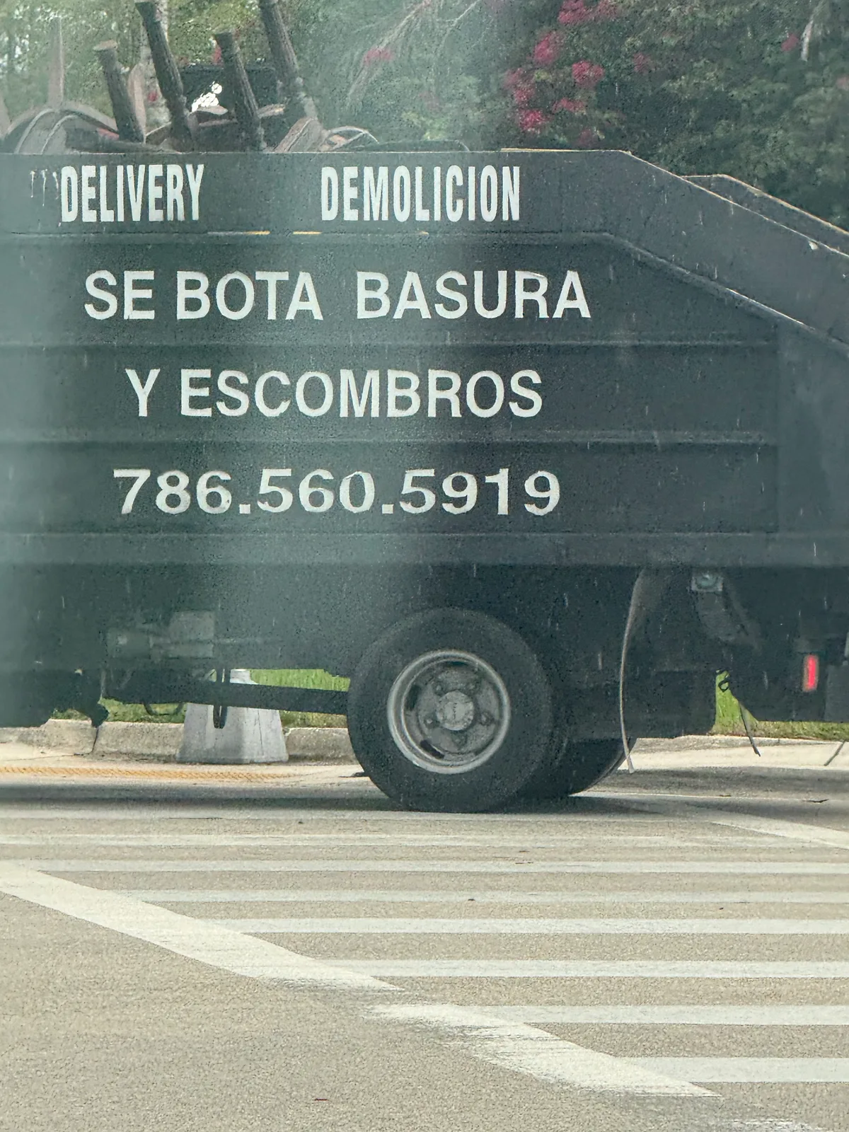Debris Removal — 786-560-5919 work vehicle displaying its business signage and contact information