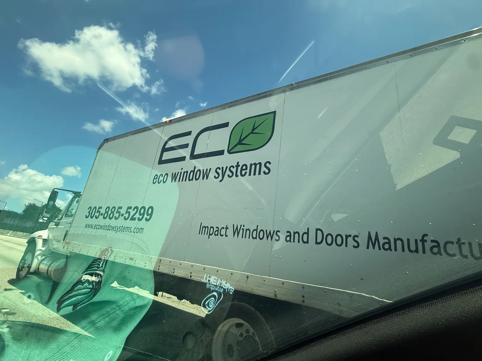 Eco Window Systems box truck advertising impact windows and doors with phone number 305-885-5299