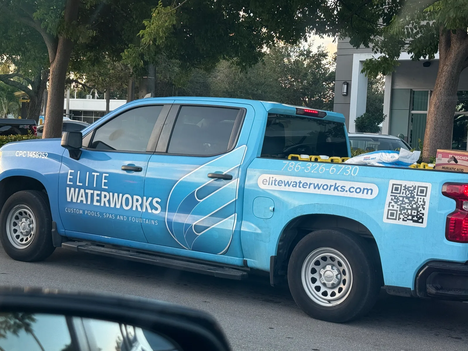 Elite Waterworks Inc. work vehicle displaying its business signage and contact information