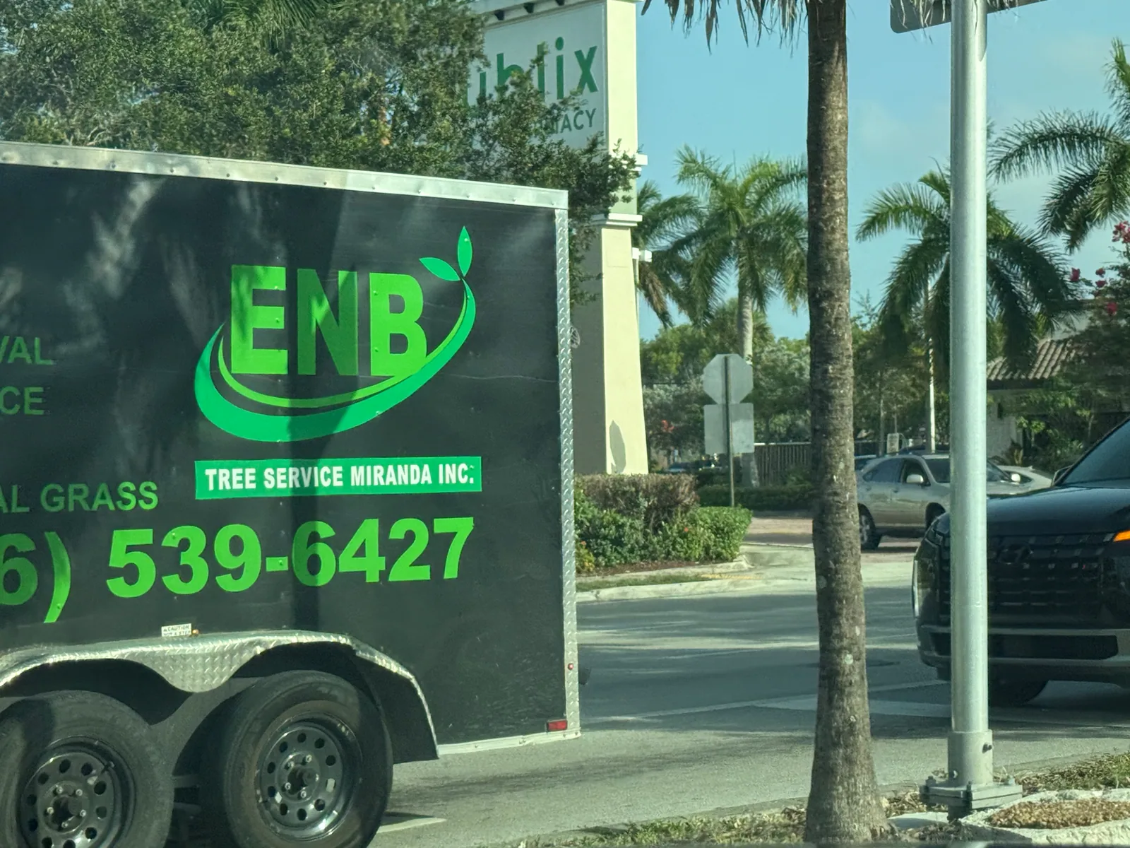 Black ENB Tree Service Miranda Inc trailer displaying phone number 786-539-6427