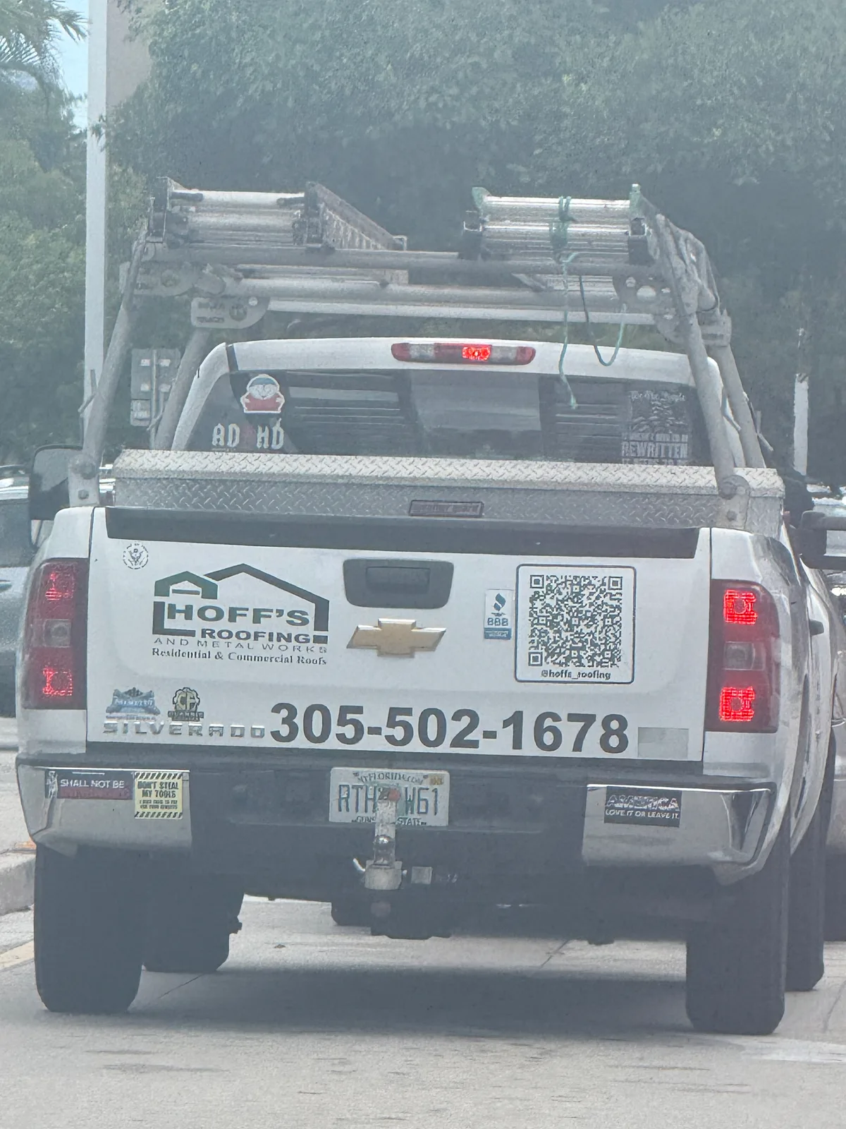 Hoff's Roofing and Metal Works work vehicle displaying its name and phone number