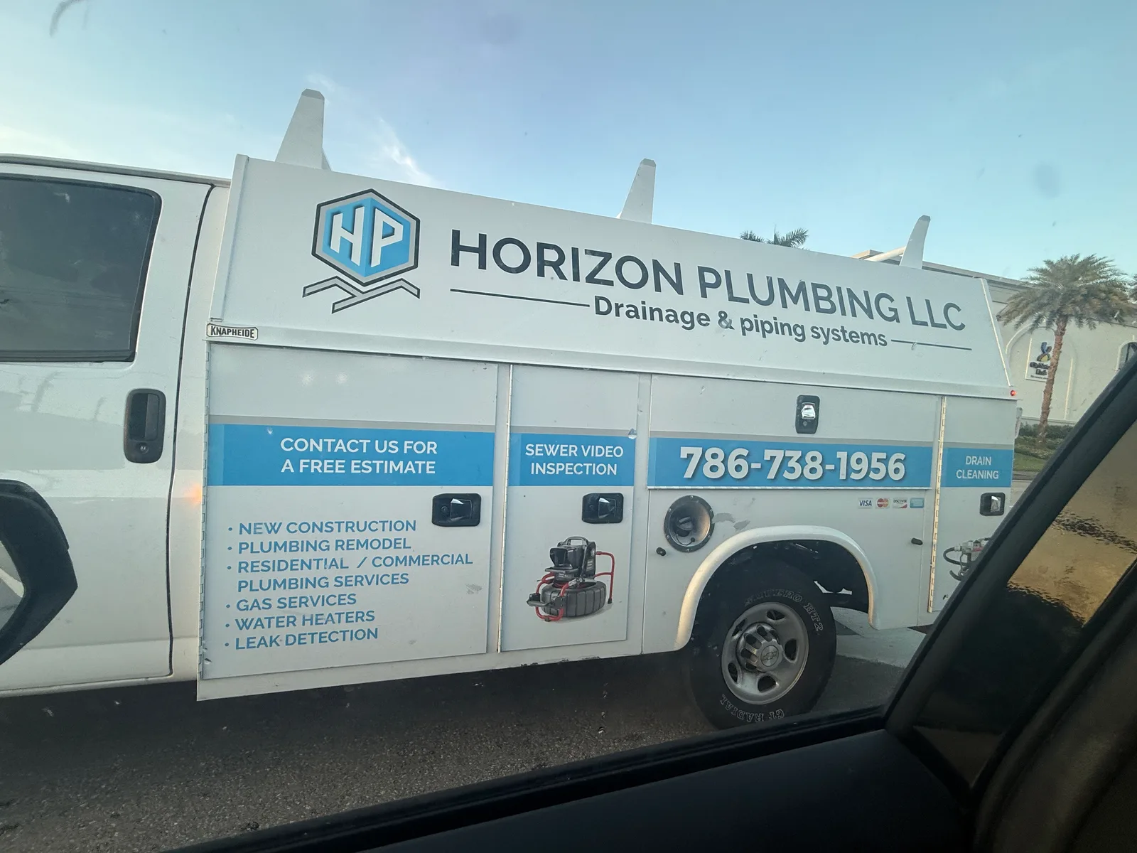 Horizon Plumbing LLC work vehicle displaying its business signage and contact information