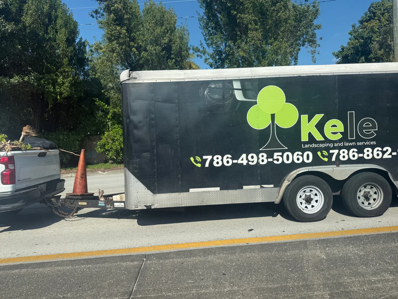 Kele Landscaping and Lawn Services work vehicle displaying services and contact details