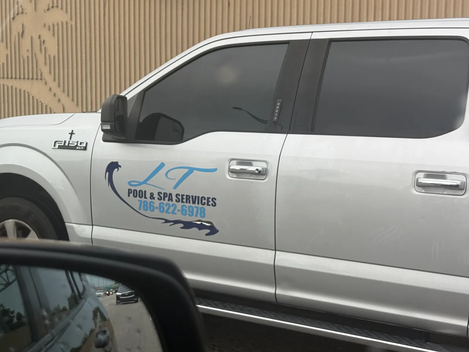 LT Pool & Spa Services work vehicle displaying its business name and contact information — photo 1 of 3