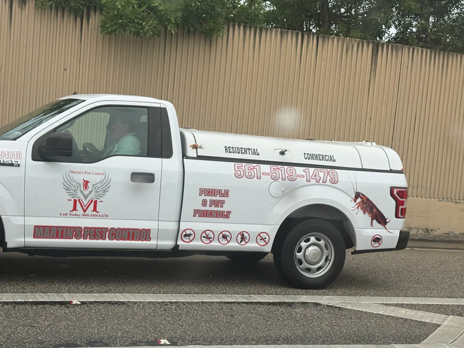 Martin's Pest Control work vehicle displaying its business name and contact information