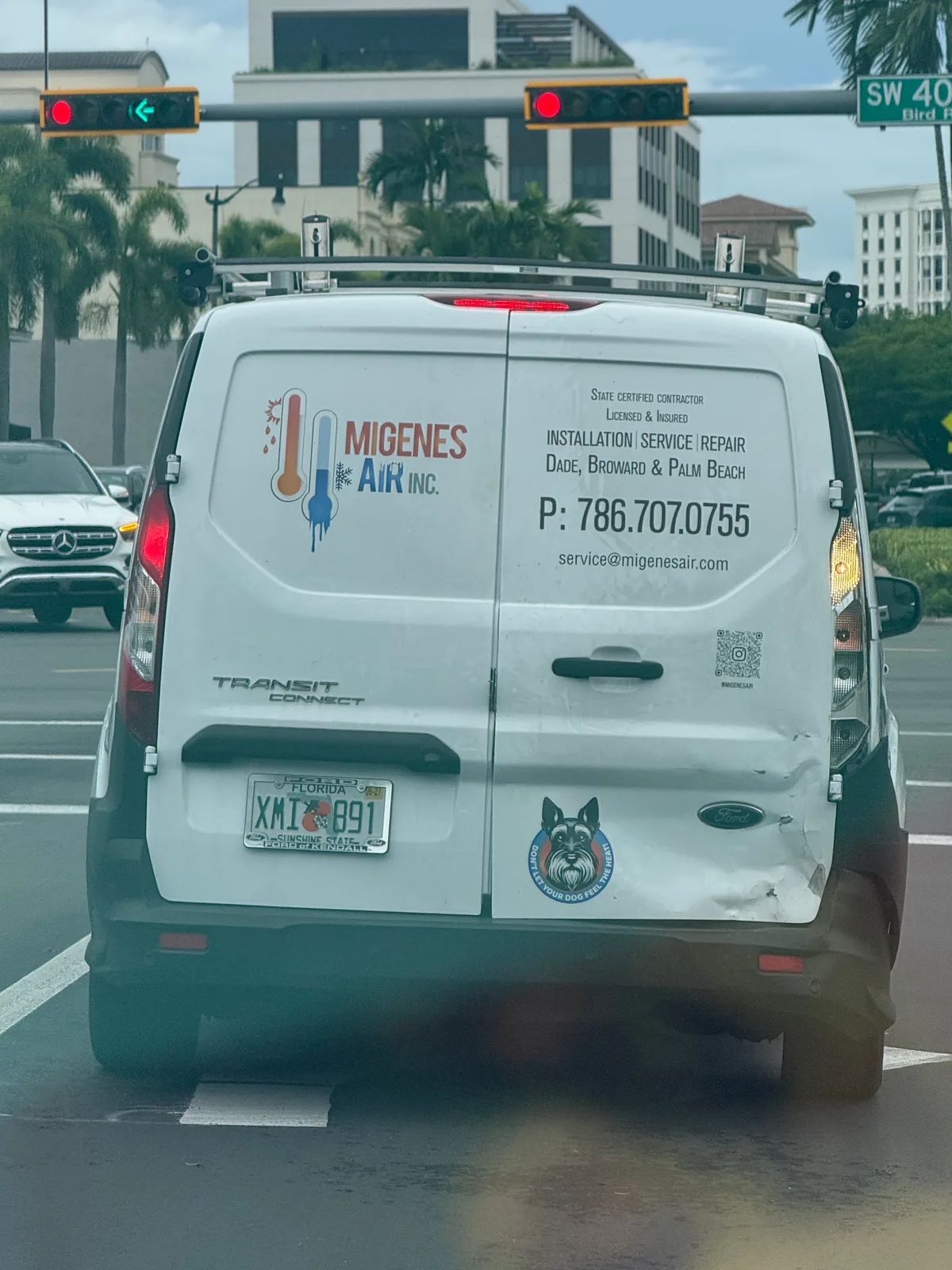 Migenes Air Inc. work vehicle displaying its business name and contact information