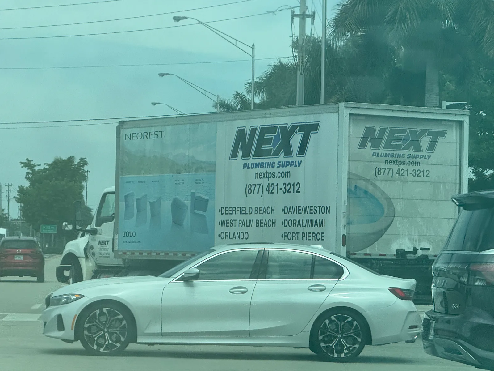 Next Plumbing Supply delivery truck displaying nextps.com, phone number 877-421-3212, and Florida service locations including Doral and Miami — photo 2 of 2