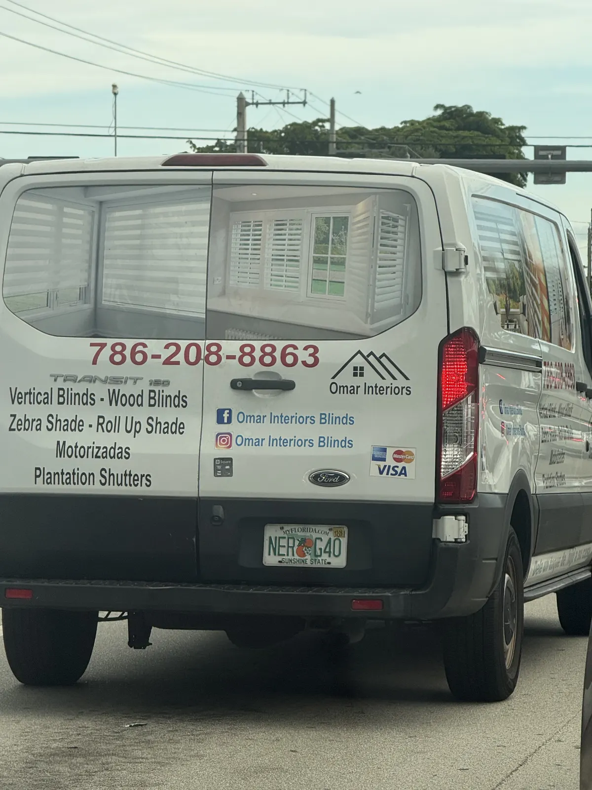 White Omar Interiors van displaying blinds, shades, shutters, social names, and phone number — photo 2 of 2