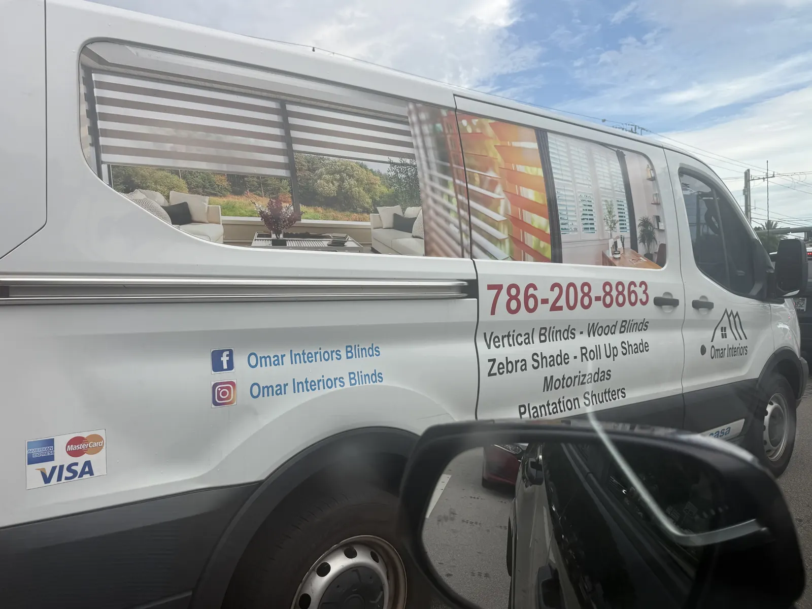 White Omar Interiors van displaying blinds, shades, shutters, social names, and phone number — photo 1 of 2