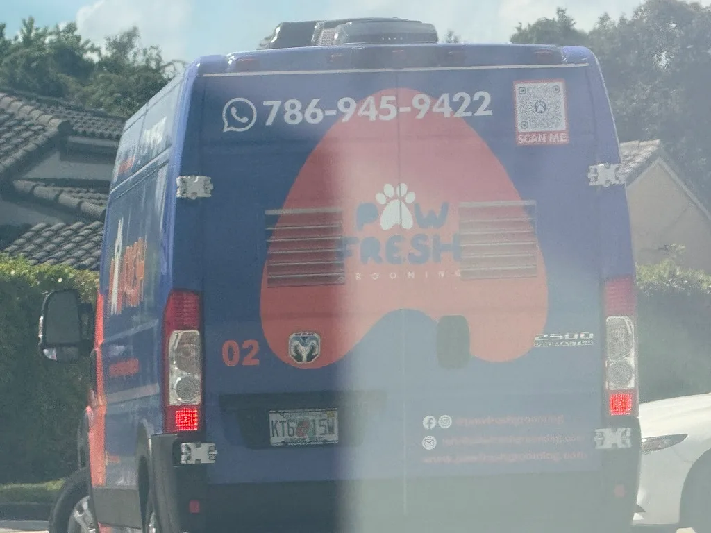 Paw Fresh Grooming work vehicle showing business branding and phone