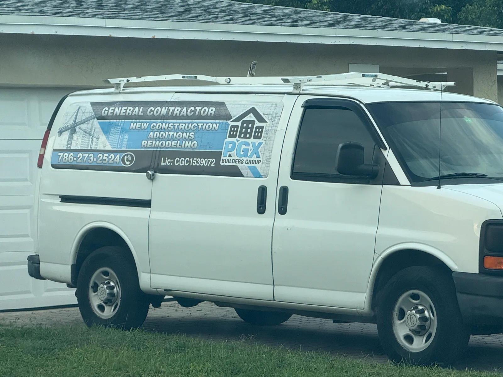 PGX Builders Group general-contractor van displaying phone number 786-273-2524, license CGC1539072, and construction services