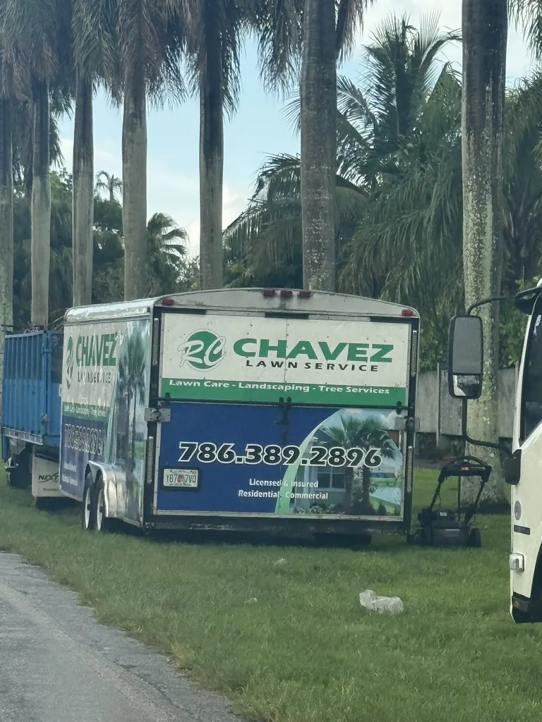 RC Chavez Lawn Service trailer advertising lawn care, landscaping, tree services, and phone number