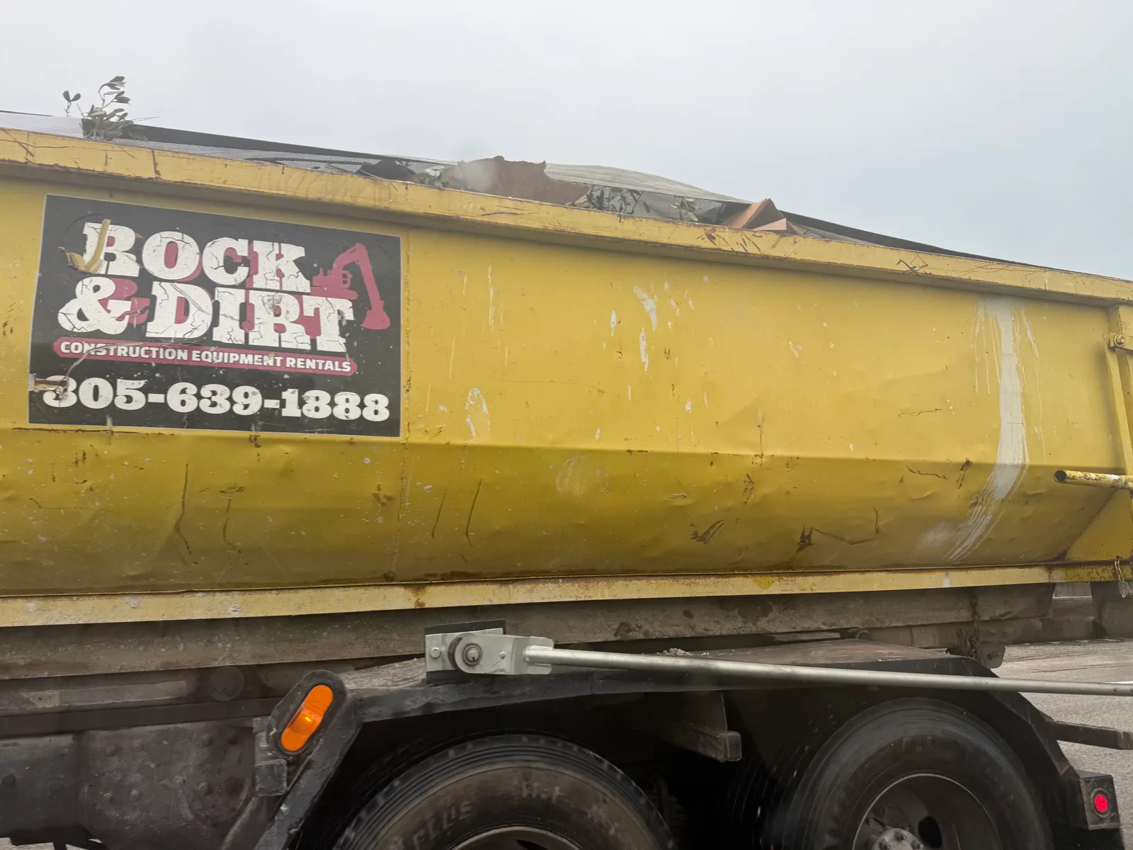 Rock & Dirt Construction Equipment Rentals work vehicle displaying its business name and contact information