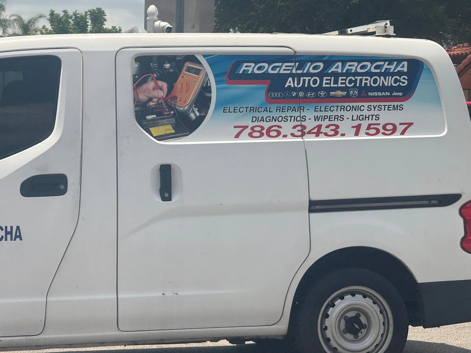 Rogelio Arocha Auto Electronics service van displaying phone number 786-343-1597 and automotive electrical services — photo 1 of 2