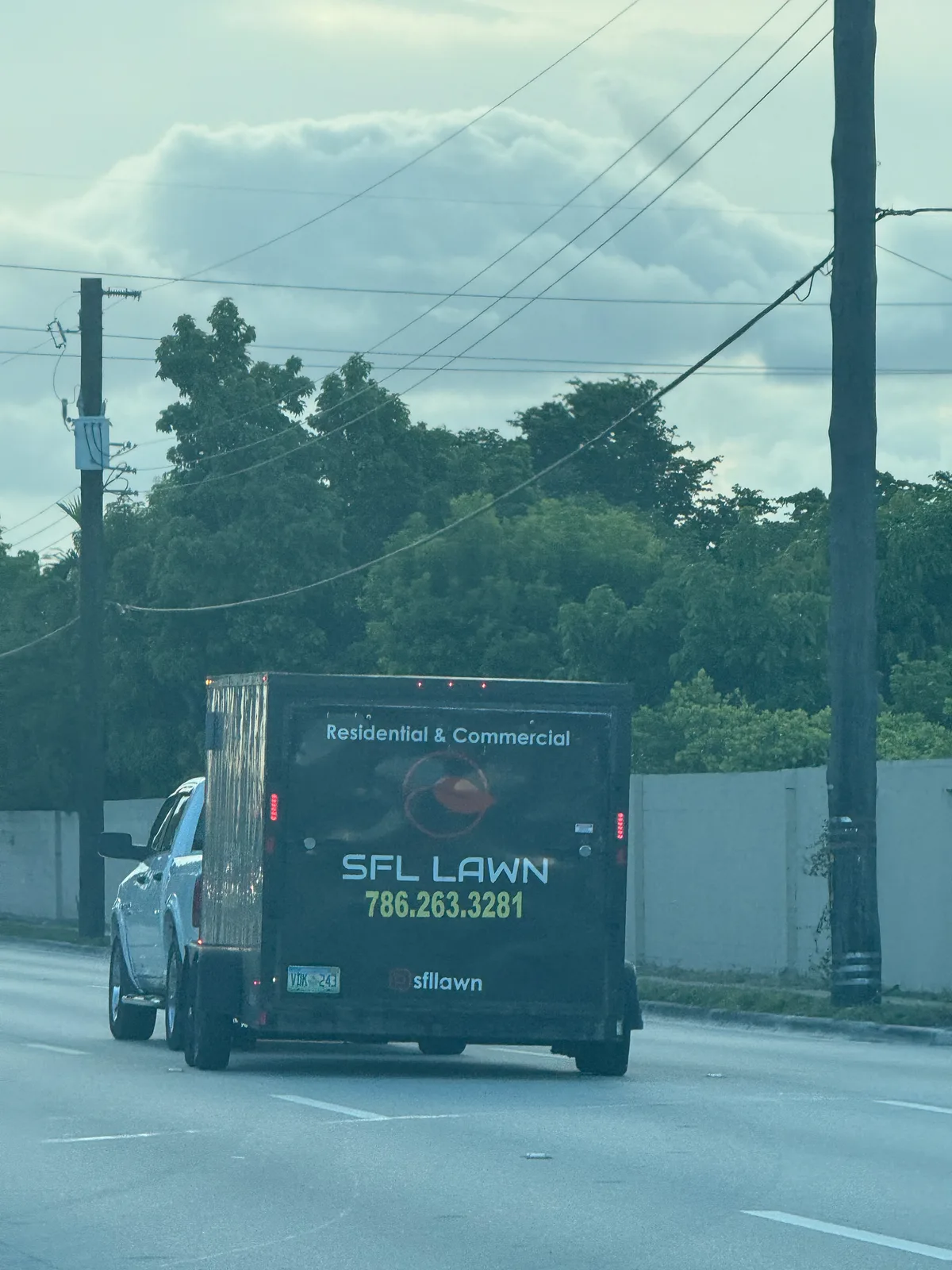 SFL Lawn work vehicle displaying its business signage and contact information