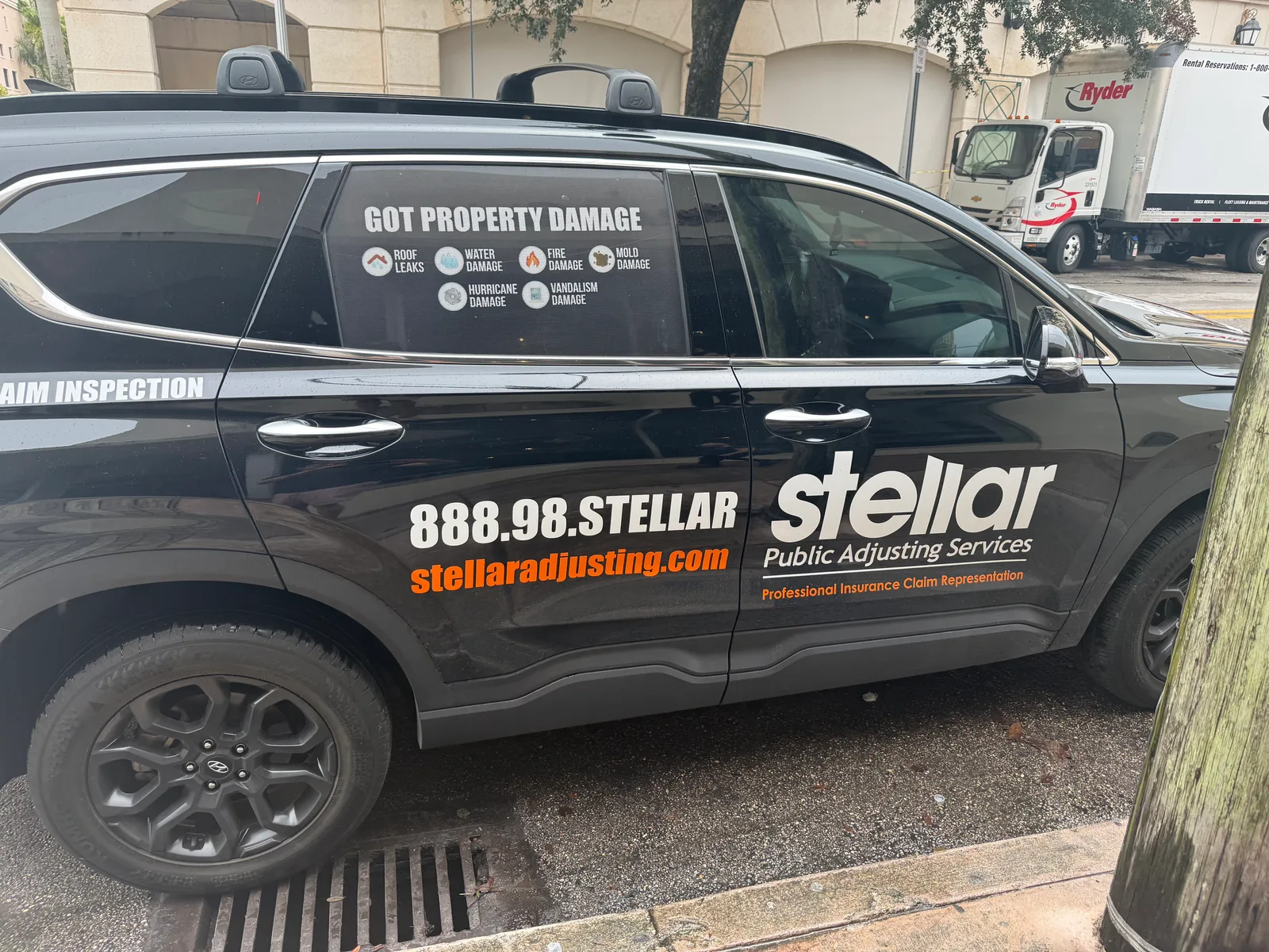 Stellar Public Adjusting Services work vehicle displaying its business name and contact information