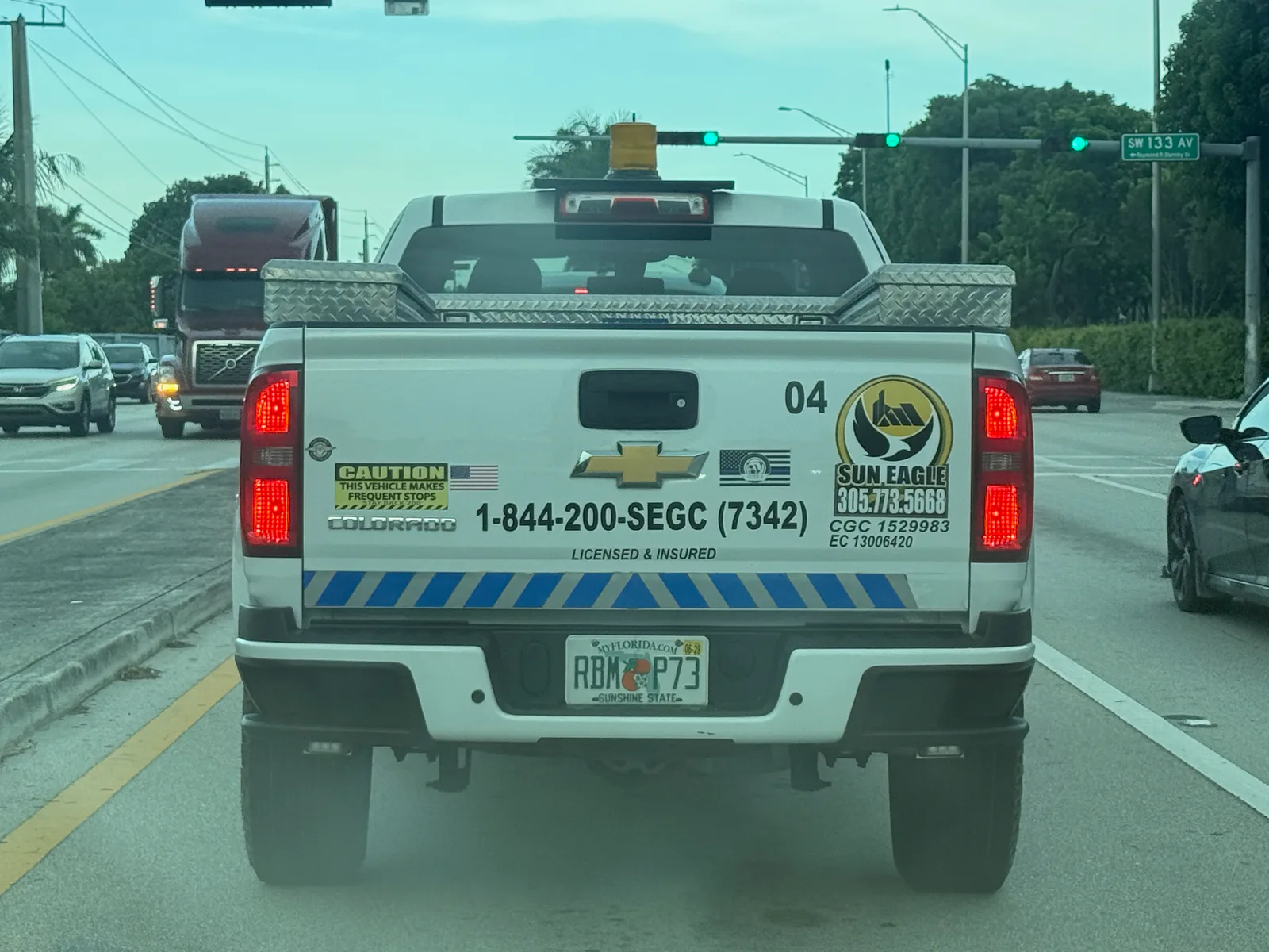 Sun Eagle contractor pickup displaying phones 305-713-5668 and 844-200-7342 with licenses CGC1529983 and EC13006420