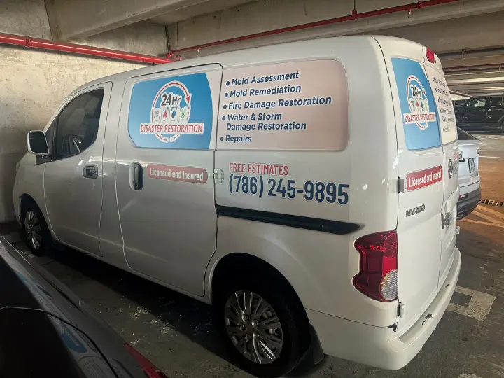 24 Hour Disaster Restoration work vehicle displaying its business signage and contact information