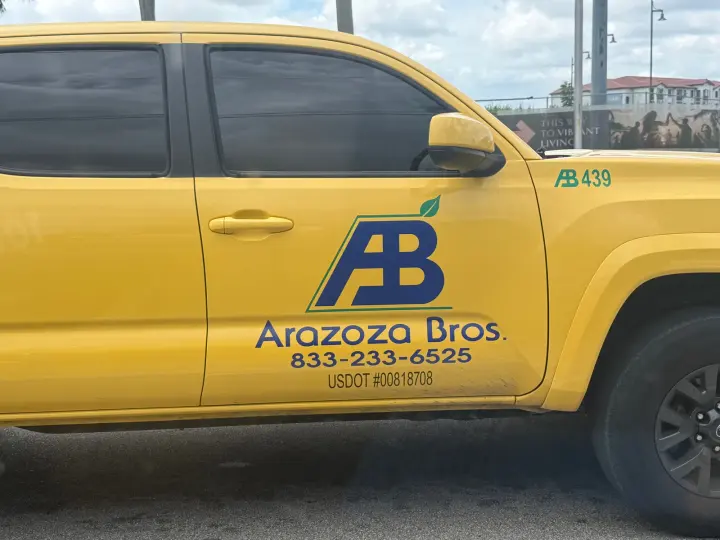 Arazoza Brothers commercial-landscaping truck displaying phone number 833-233-6525 and USDOT 00818708