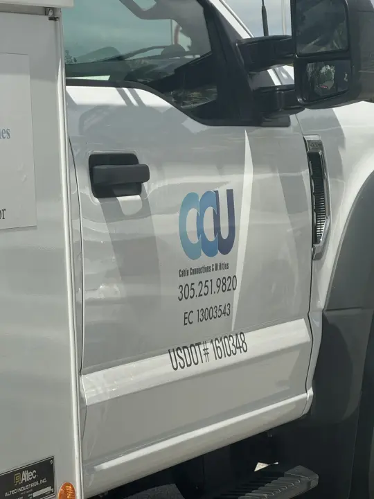 White Cable Connections and Utilities service truck showing a Miami phone number and license