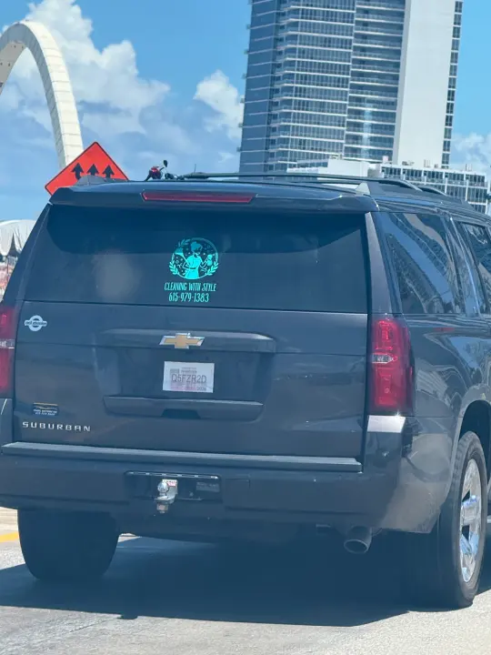 Dark SUV displaying a Cleaning With Style logo and phone number 561-579-1383