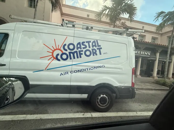 White Coastal Comfort Inc. air-conditioning service van with blue and orange sun logo