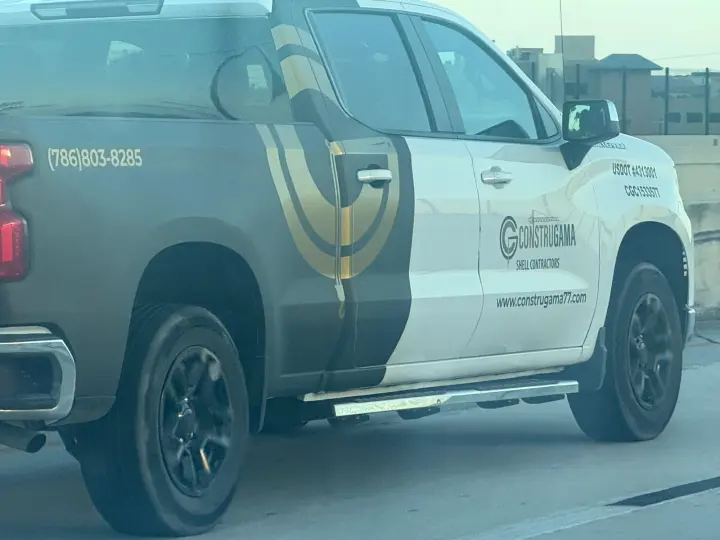 Construgama 77 shell-contractor pickup displaying phone number and company website