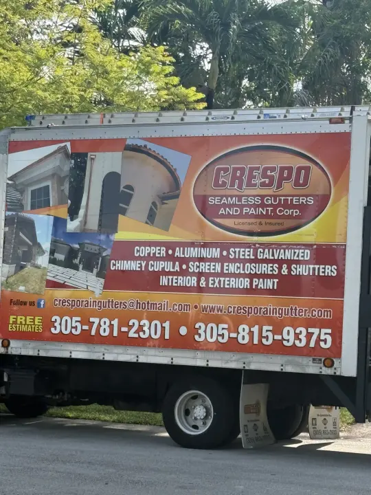 Orange Crespo Seamless Gutters and Paint work truck showing gutter services and contact details