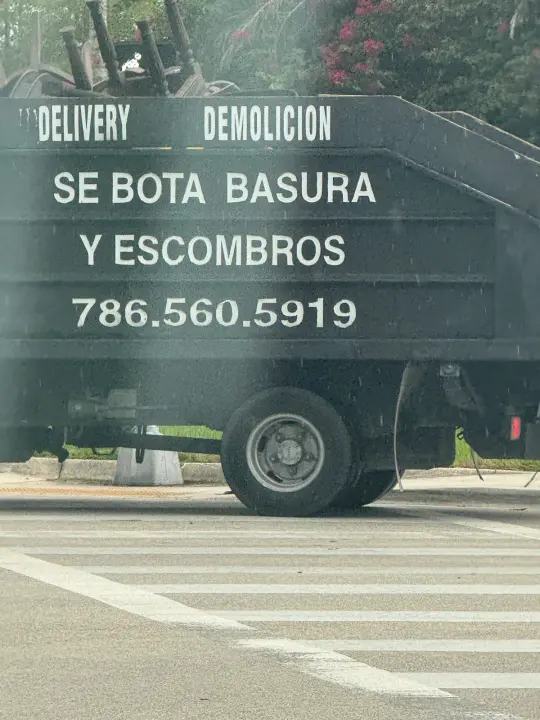 Debris Removal — 786-560-5919 work vehicle displaying its business signage and contact information