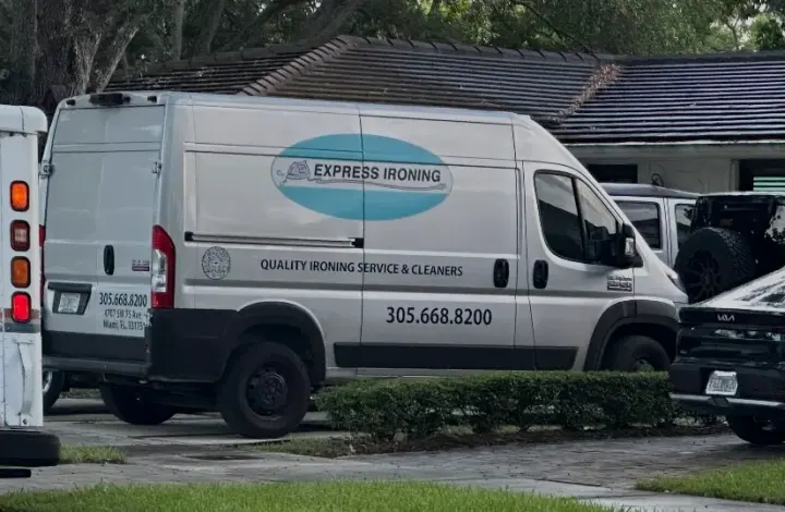 Express Ironing work vehicle displaying its business signage and contact information