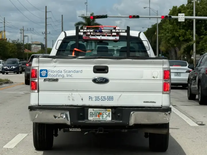 Florida Standard Roofing work truck displaying phone number 305-529-5899