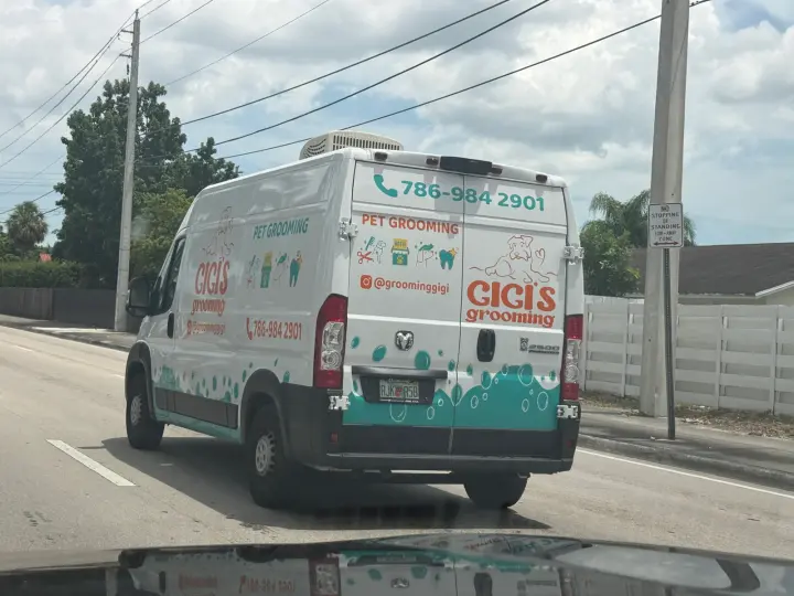 Gigi's Grooming van displaying phone number 786-984-2901 and Instagram handle groominggigi