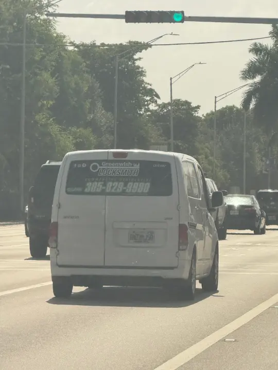 White Greenwish Locksmith service van displaying phone number 305-829-9980 and license LR01087