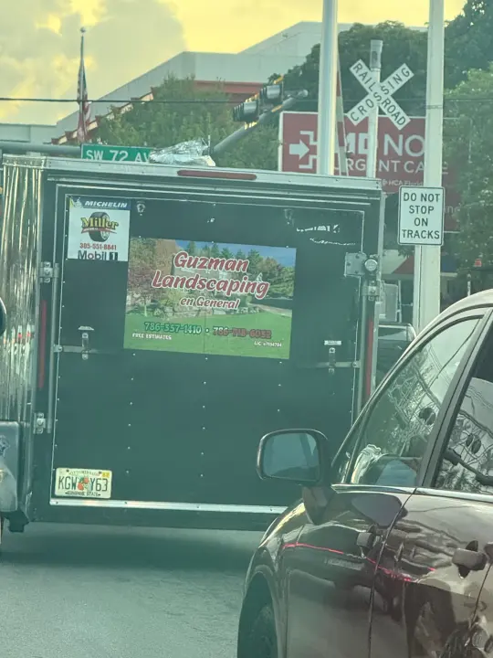 Guzman Landscaping en General trailer displaying phone number 786-357-1410 and free-estimate wording