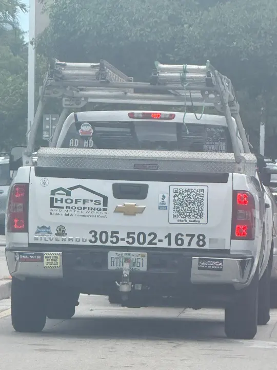 Hoff's Roofing and Metal Works work vehicle displaying its name and phone number