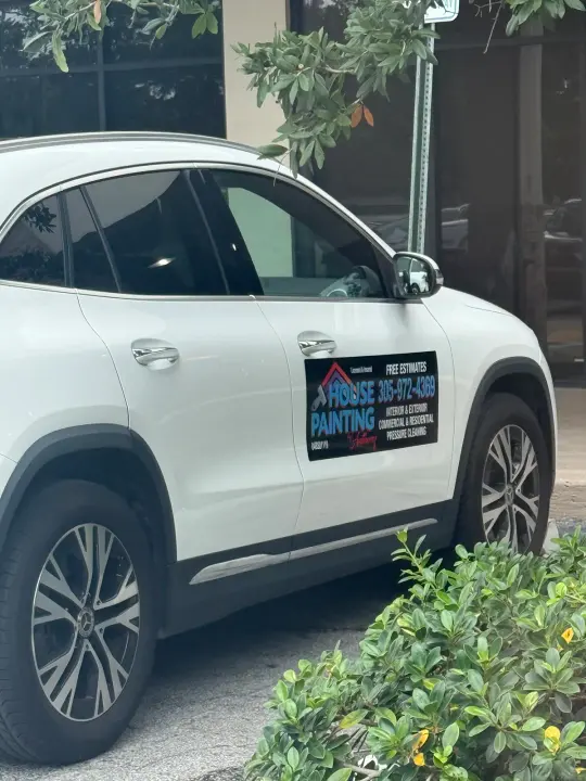 White SUV displaying a House Painting sign with phone number 305-972-4369 and painting services
