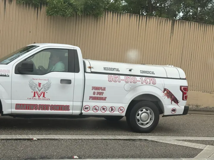 Martin's Pest Control work vehicle displaying its business name and contact information