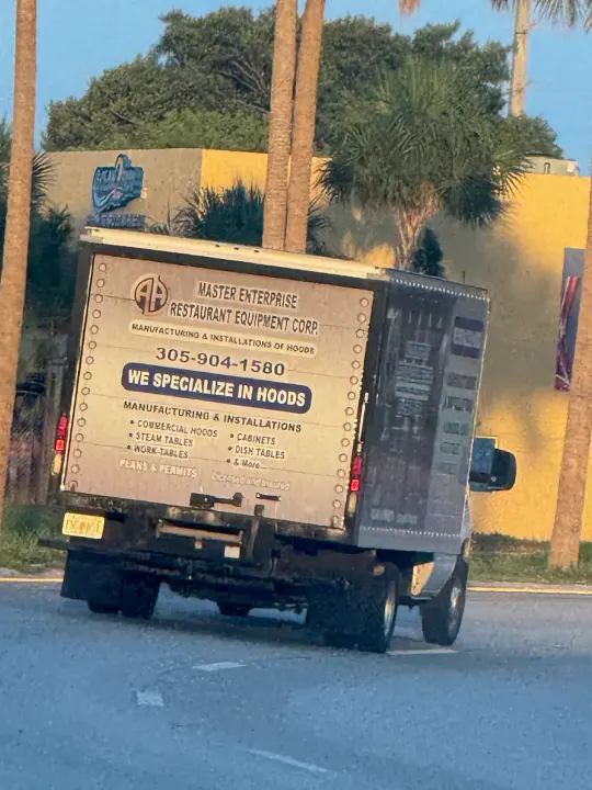 Master Enterprise Restaurant Equipment Corp truck displaying phone number 305-904-1580 and commercial hood and kitchen-equipment services