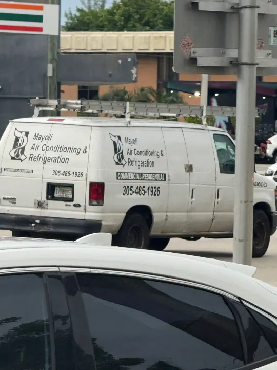 Mayoli Air Conditioning & Refrigeration work vehicle displaying its business signage and contact information