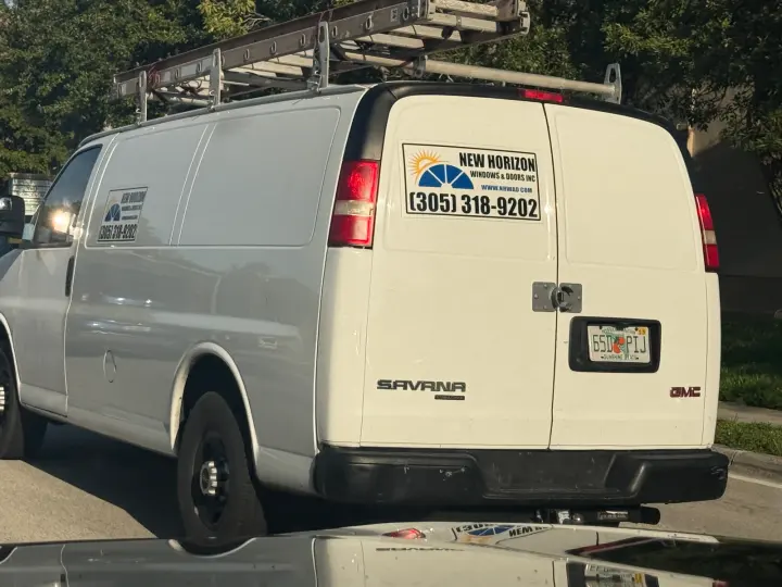 New Horizon Windows and Doors Inc. work vehicle displaying its name and phone number