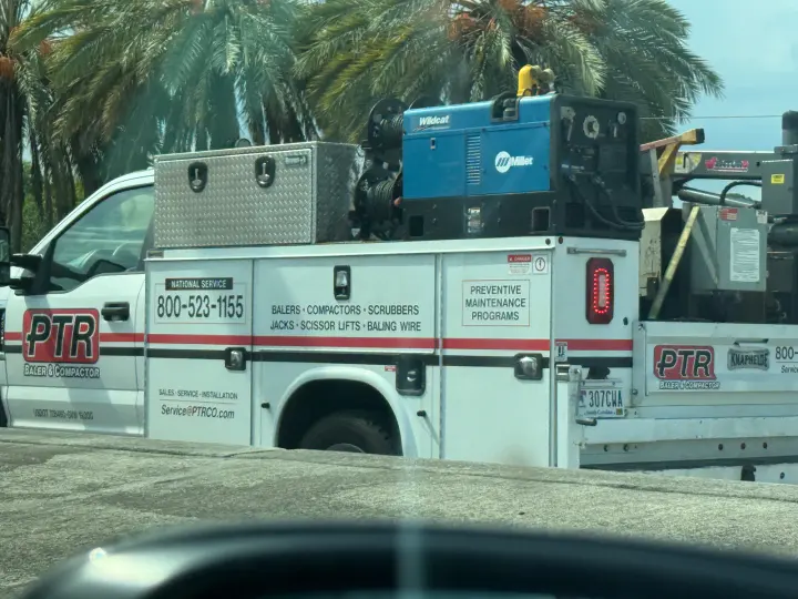 PTR Baler and Compactor service truck displaying national phone number 800-523-1155 and commercial waste-equipment services