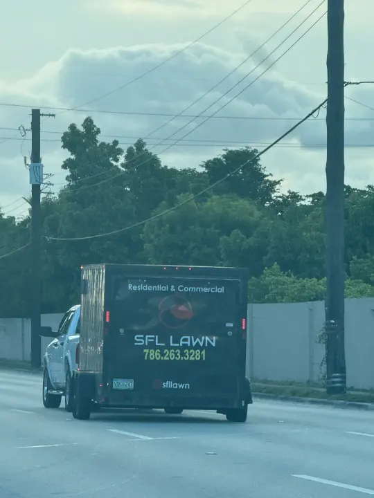 SFL Lawn work vehicle displaying its business signage and contact information